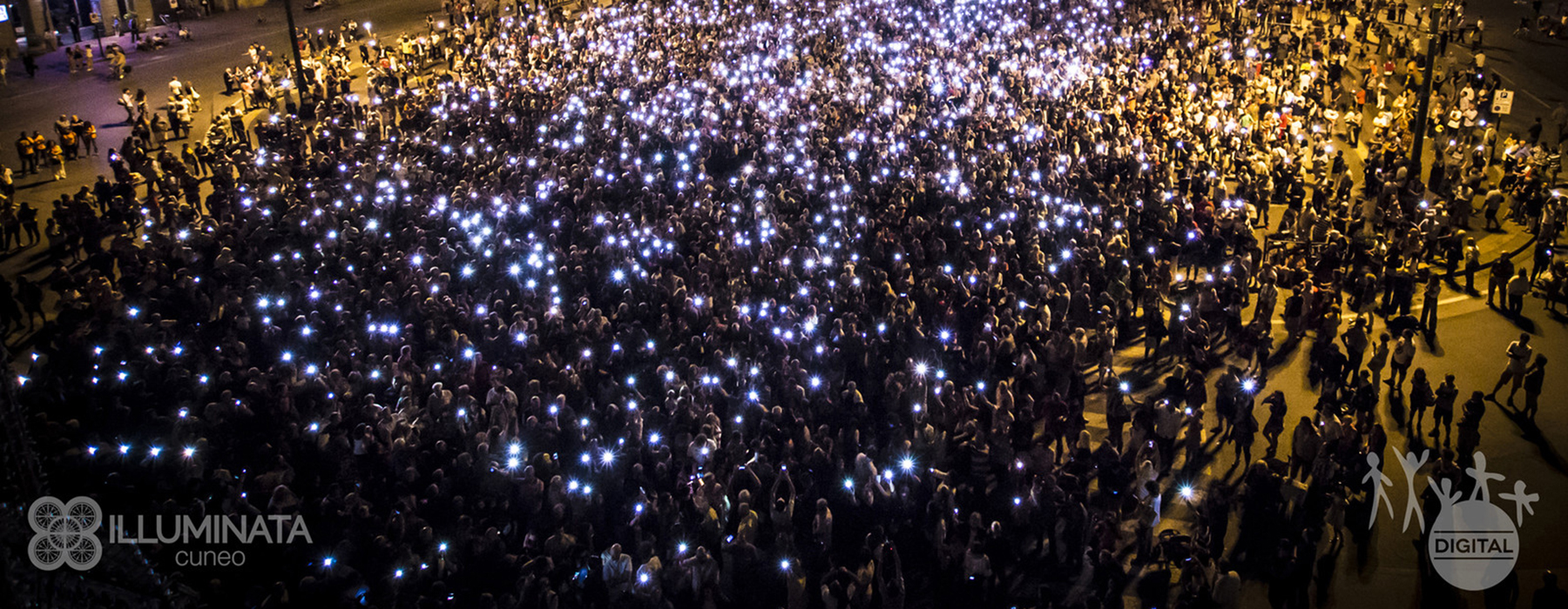 Foto di una folla durante una sera con numerose luci colorate